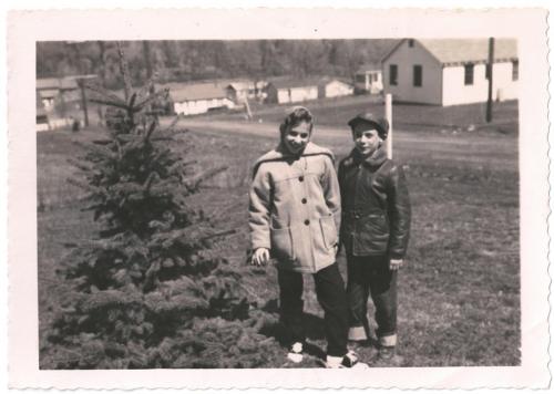 Arlene and Larry by the blue spruce in Monroe, NY, 1958.